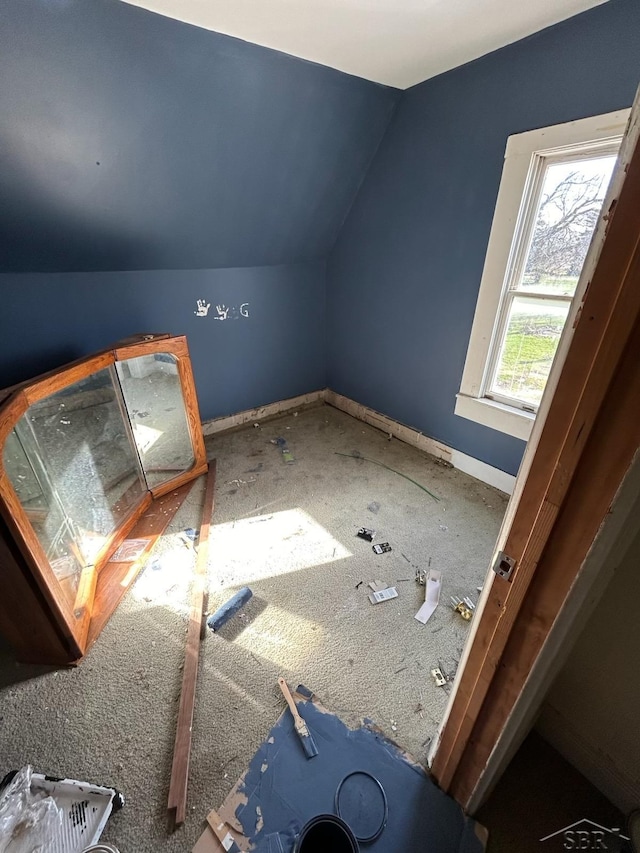 bonus room featuring baseboards and vaulted ceiling