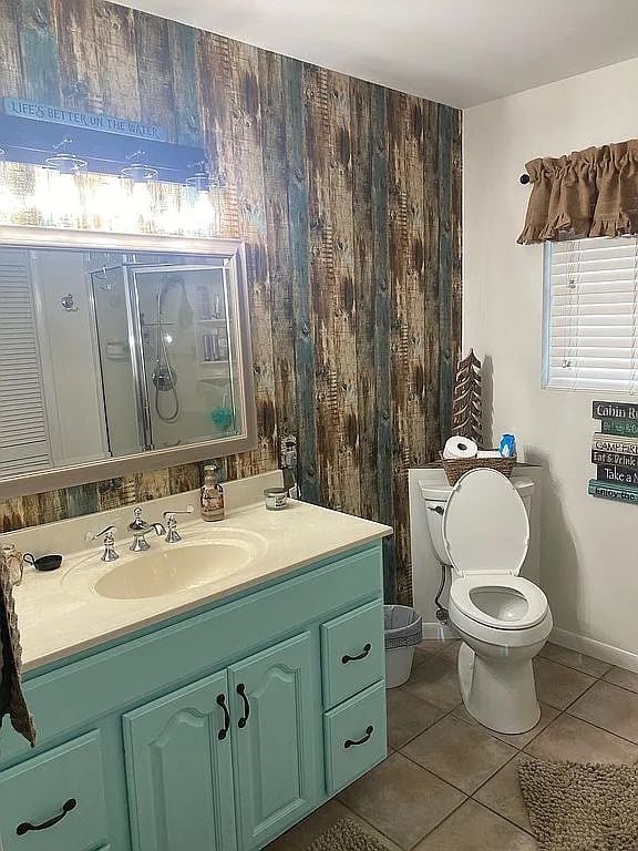 bathroom with tile patterned flooring, vanity, and toilet