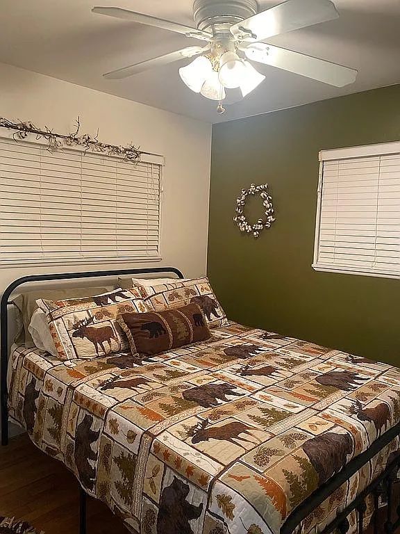 bedroom with hardwood / wood-style flooring and ceiling fan