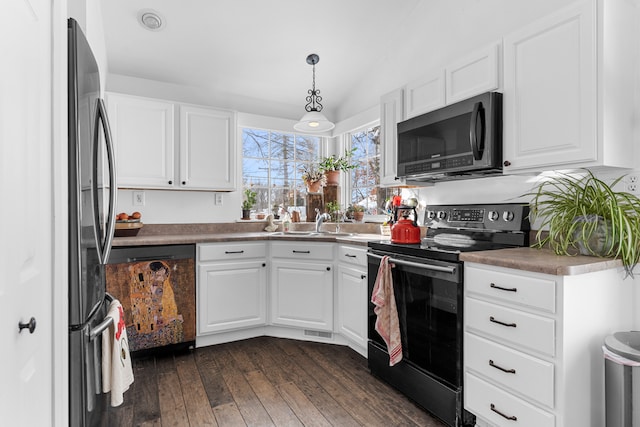 kitchen with dark wood-style flooring, white cabinetry, decorative light fixtures, and black appliances