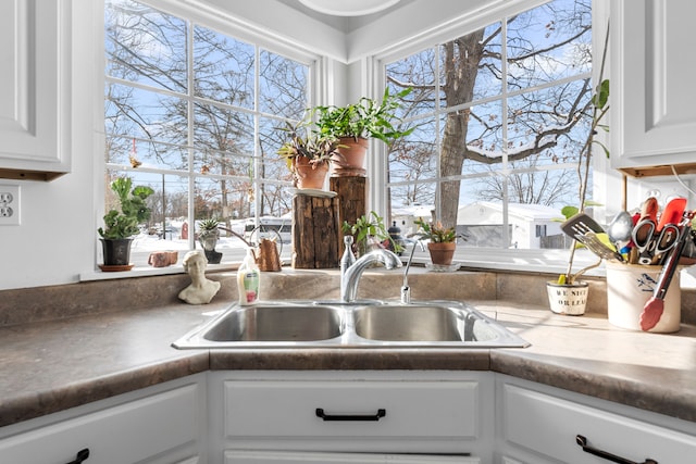 kitchen featuring a sink and white cabinetry