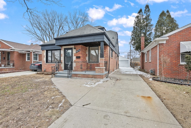 view of front of property featuring a garage, an outdoor structure, and covered porch