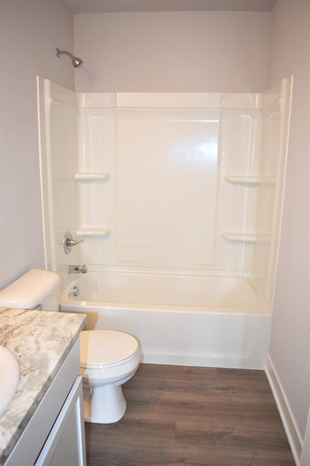 full bathroom with toilet, wood-type flooring, shower / washtub combination, and vanity