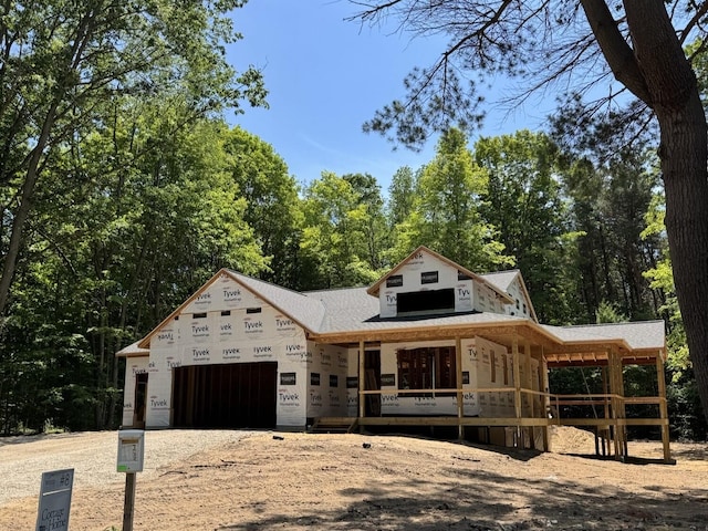 76831 Wood Crest Ct, South Haven, MI 49090 - property under construction featuring dirt driveway, covered porch, and a garage
