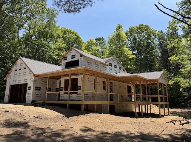 76831 Wood Crest Ct, South Haven, MI 49090 - property in mid-construction with a garage, covered porch, and view of scattered trees