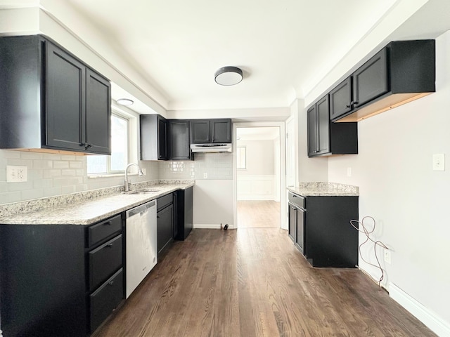 kitchen with sink, backsplash, dishwasher, dark hardwood / wood-style flooring, and light stone countertops