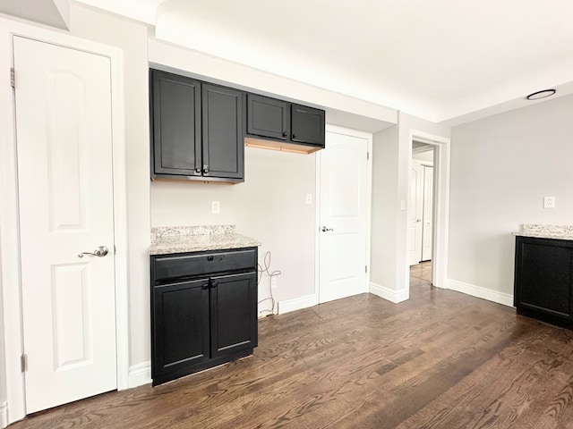 kitchen featuring light stone countertops and dark hardwood / wood-style floors