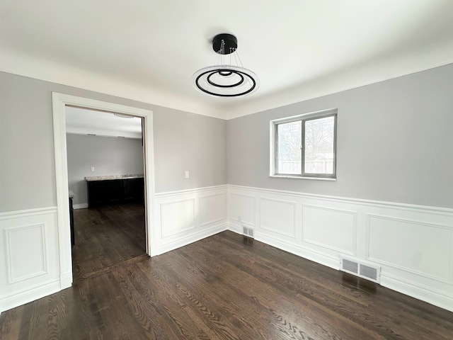 unfurnished room featuring dark wood-type flooring