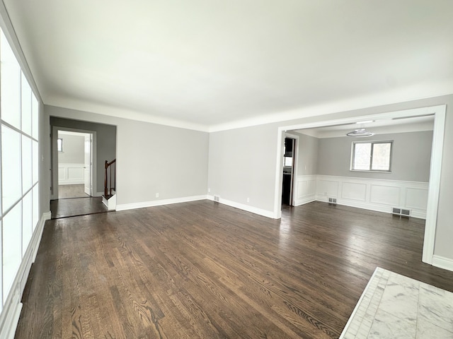 unfurnished living room with dark wood-type flooring