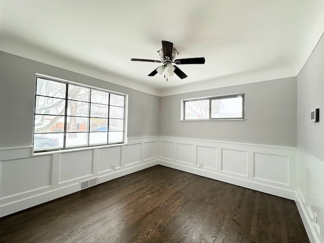 spare room featuring ceiling fan and dark hardwood / wood-style flooring