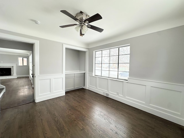 unfurnished bedroom featuring dark hardwood / wood-style floors and ceiling fan