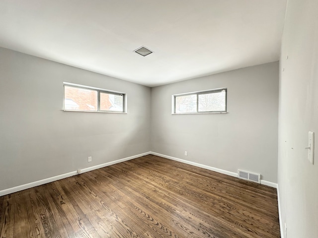 unfurnished room featuring dark hardwood / wood-style flooring