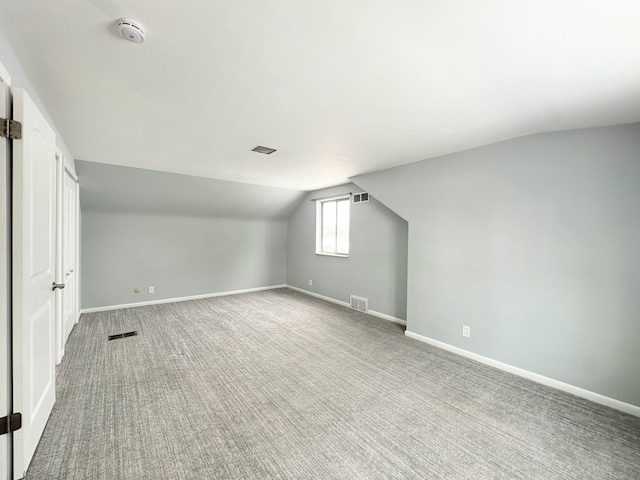 bonus room featuring carpet and vaulted ceiling