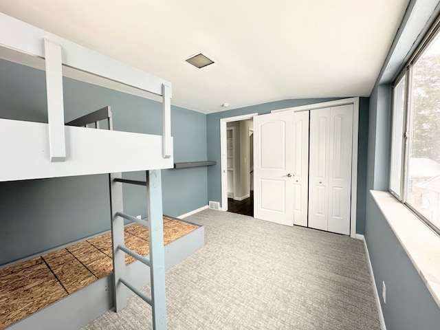 bedroom with carpet flooring and a closet