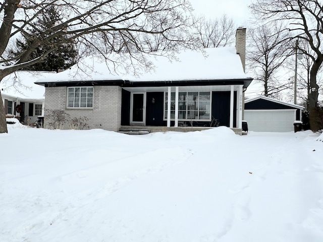 view of front of house with a garage and an outdoor structure