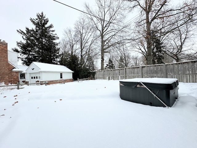 snowy yard with a hot tub