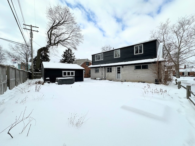 snow covered property with a hot tub