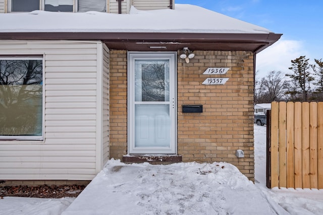 view of snow covered property entrance