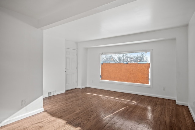 unfurnished room with wood-type flooring