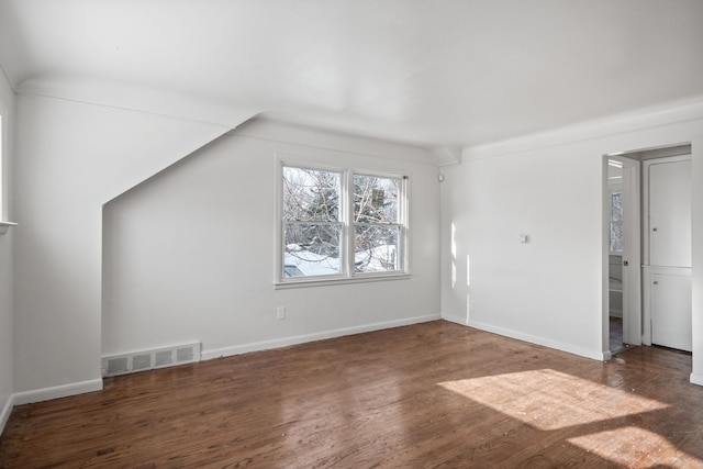 additional living space with dark hardwood / wood-style floors