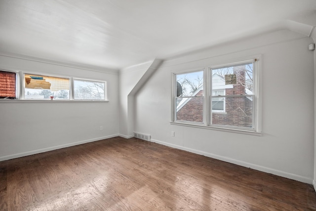 bonus room with dark hardwood / wood-style flooring