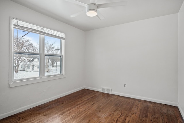 unfurnished room with dark hardwood / wood-style floors and ceiling fan