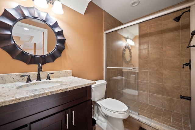 full bath featuring vanity, a shower stall, and toilet