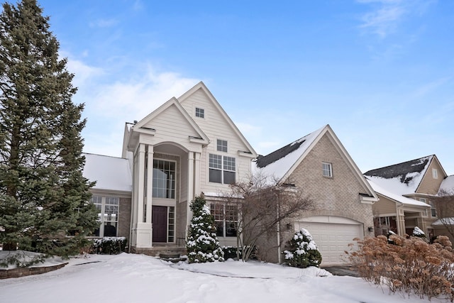 traditional home featuring an attached garage and brick siding