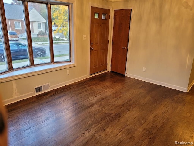 unfurnished room featuring dark hardwood / wood-style flooring