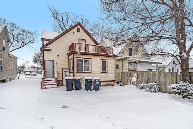 snow covered house with a balcony