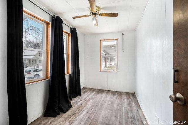 unfurnished room with ceiling fan and light wood-type flooring