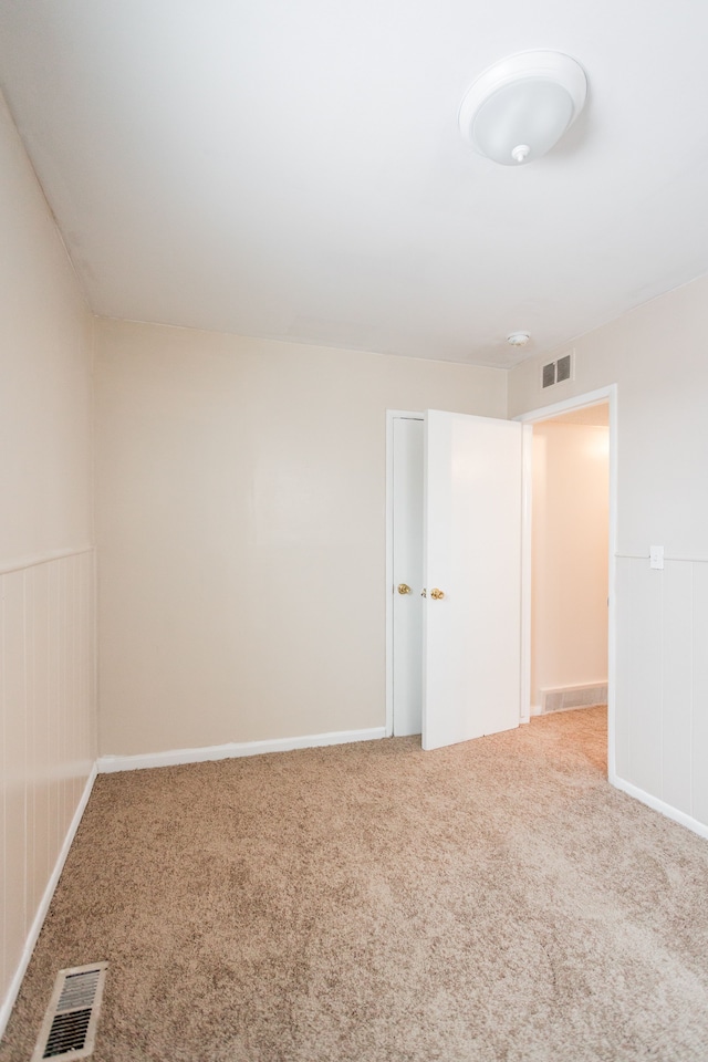 unfurnished room featuring carpet flooring