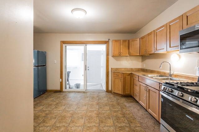 kitchen with sink and appliances with stainless steel finishes