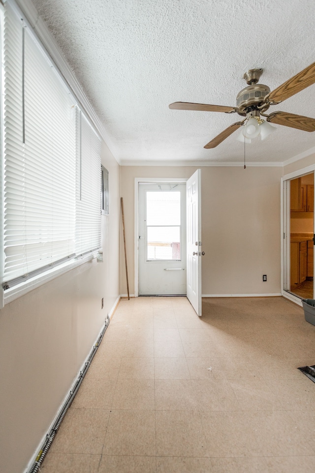 interior space with ceiling fan, crown molding, and a textured ceiling