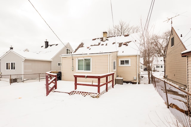 snow covered property with cooling unit