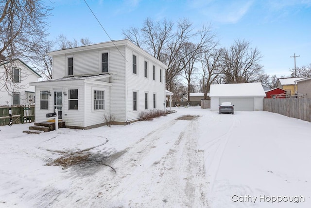 view of front of house with a garage and an outdoor structure