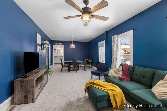 living room featuring carpet flooring and ceiling fan