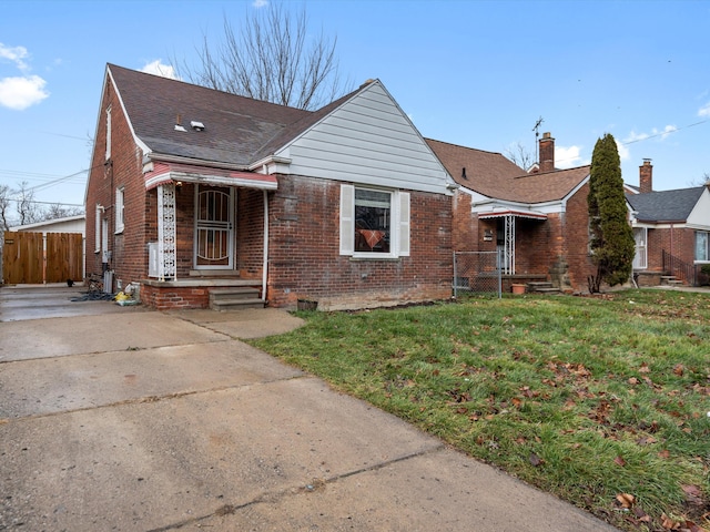 bungalow-style home with a front lawn