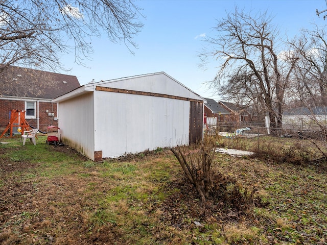 view of side of home with a yard and a playground