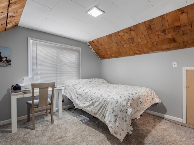 carpeted bedroom with vaulted ceiling and wooden ceiling