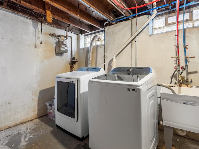 laundry area featuring sink, plenty of natural light, and washing machine and clothes dryer