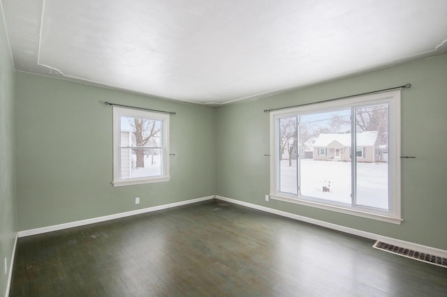 spare room featuring dark hardwood / wood-style floors