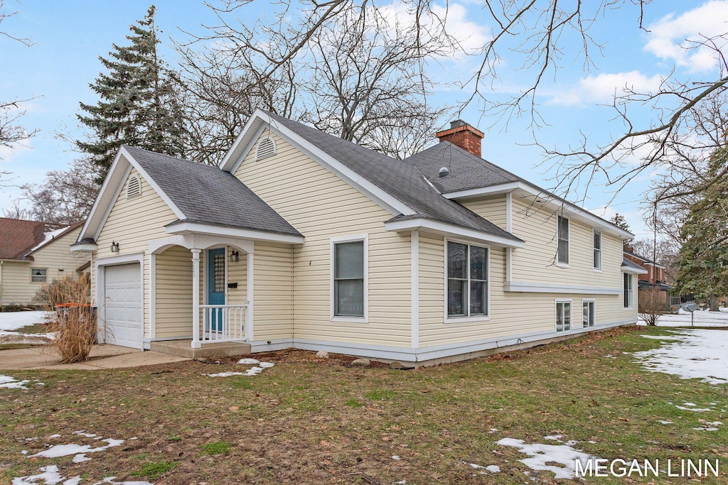 exterior space with a garage and a front lawn