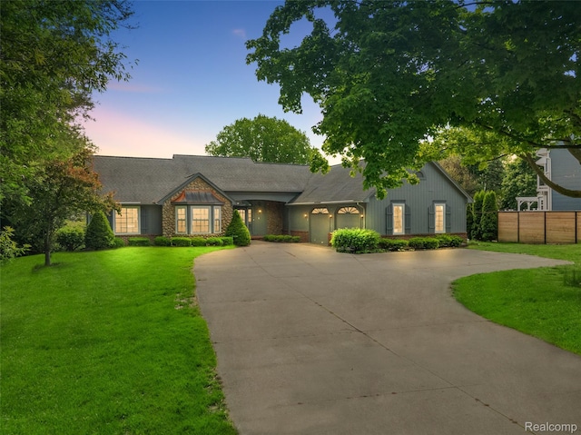 385 Joslyn Rd, Lake Orion, MI 48362 - view of front facade featuring curved driveway, a front yard, and a garage