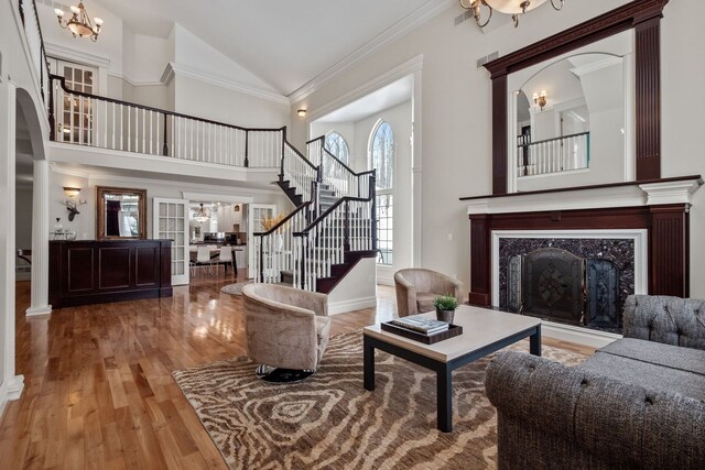 6705 College Park, Clarkston, MI 48346 - living area with stairway, wood finished floors, high vaulted ceiling, arched walkways, and a premium fireplace