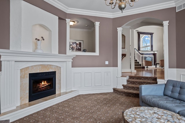 6705 College Park, Clarkston, MI 48346 - living area with crown molding, arched walkways, visible vents, stairs, and a premium fireplace