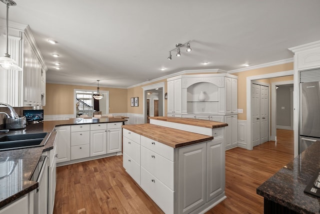 6705 College Park, Clarkston, MI 48346 - kitchen featuring ornamental molding, wood counters, white cabinetry, appliances with stainless steel finishes, and a sink