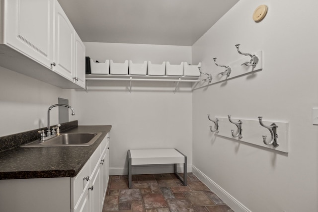 6705 College Park, Clarkston, MI 48346 - laundry area with a sink, baseboards, and stone finish flooring