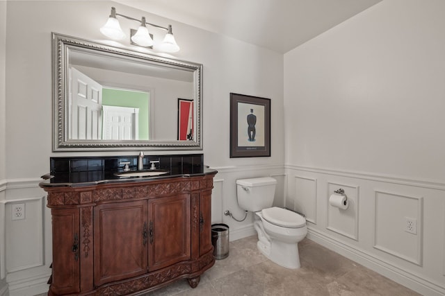 6705 College Park, Clarkston, MI 48346 - half bath featuring toilet, a decorative wall, vanity, and a wainscoted wall