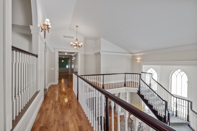 6705 College Park, Clarkston, MI 48346 - corridor featuring visible vents, a chandelier, light wood-style floors, crown molding, and high vaulted ceiling